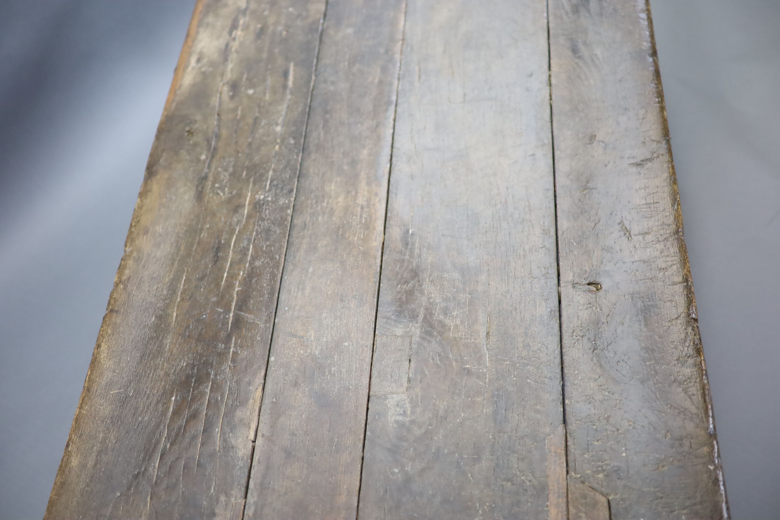 A 17th century oak and elm refectory table, L.255cm W.82cm H.78cm